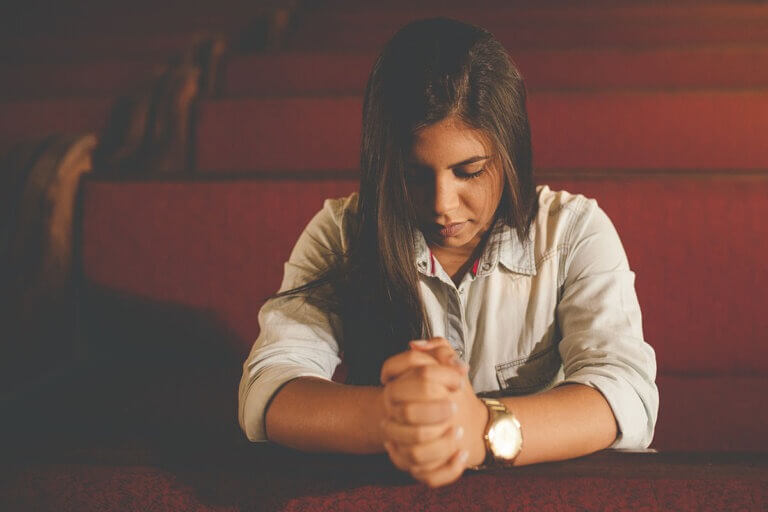Praying in pew